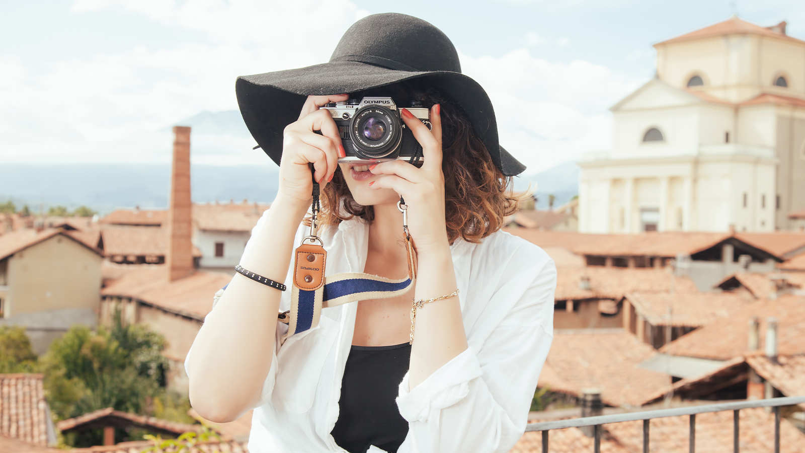 a female traveler posing with a camera