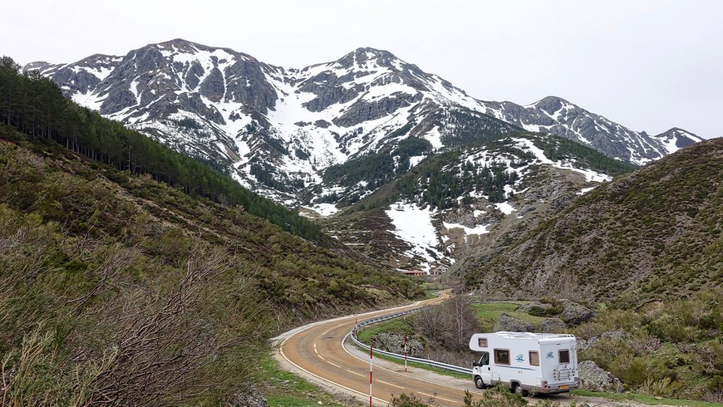 an image of an RV passing through hills