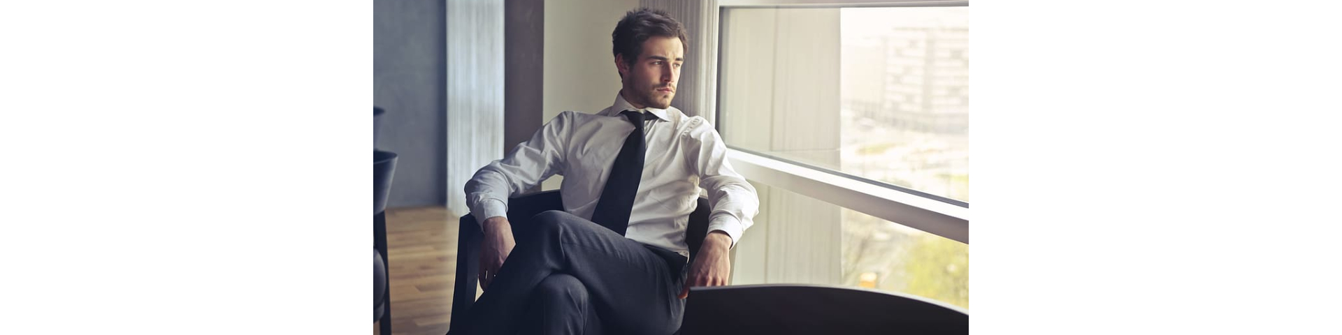 an image of a person wearing a white dress shirt while sitting